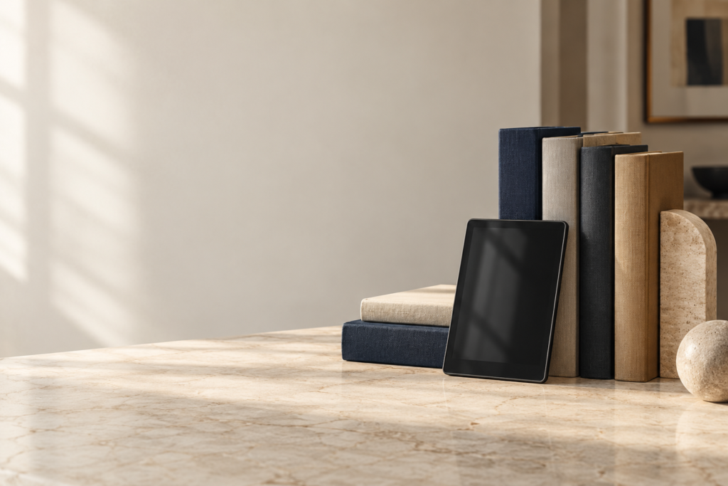 Books and a tablet arranged on a stone shelf